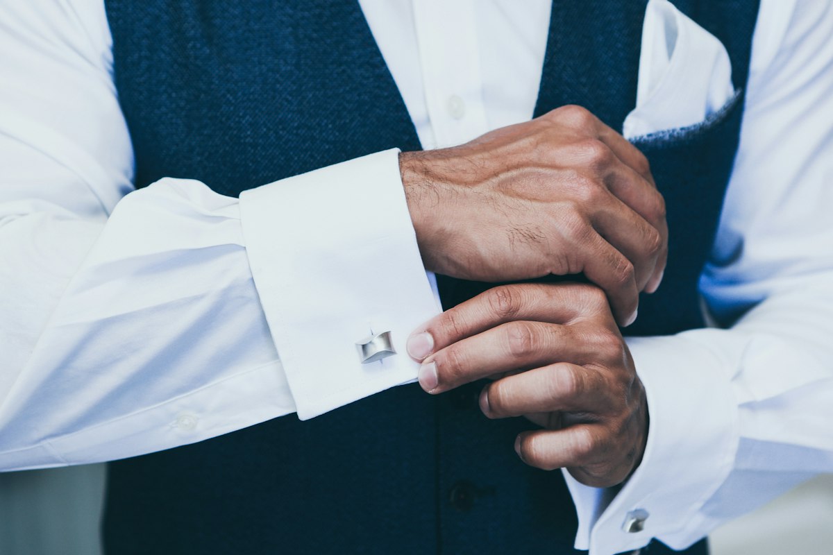 A white double cuff shirt fastened with a cufflink